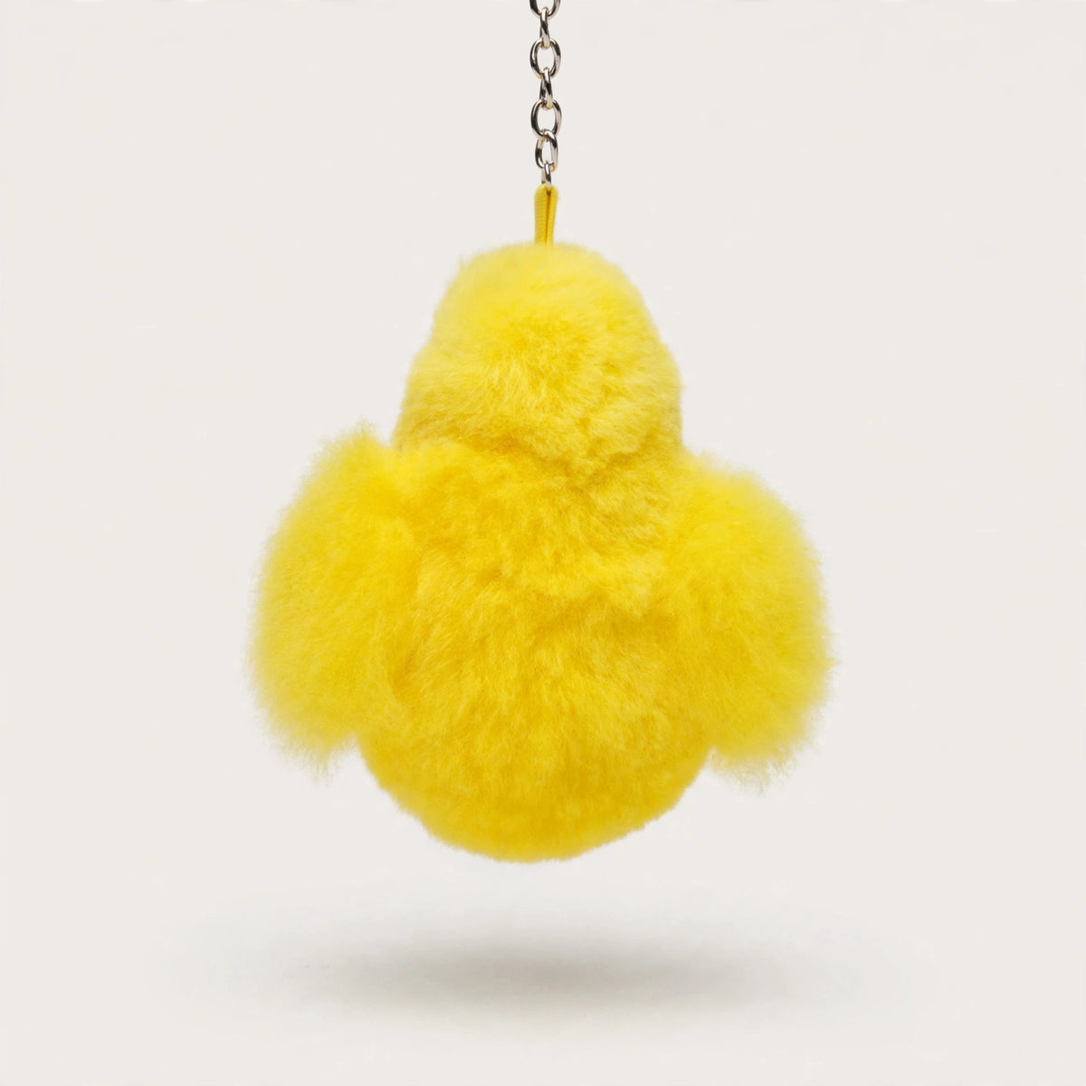 Back view of the fluffy yellow chick keychain