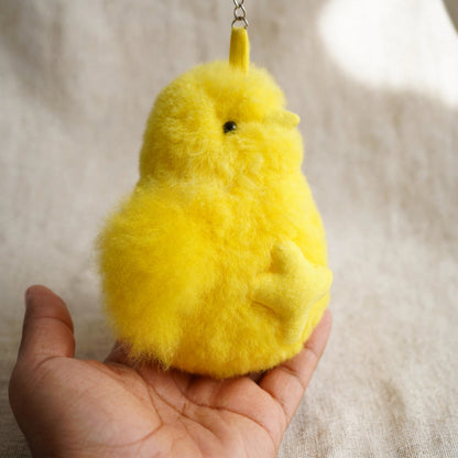 Alpaca fur chick keychain held in hand to show size, about 6 inches